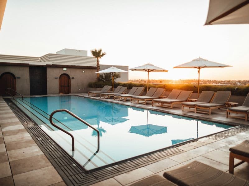 A clean backyard swimming pool on a sunny day
