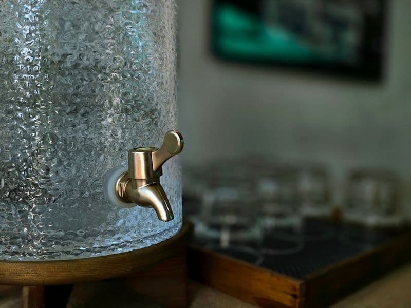 A glass of clean filtered water poured in a bright kitchen