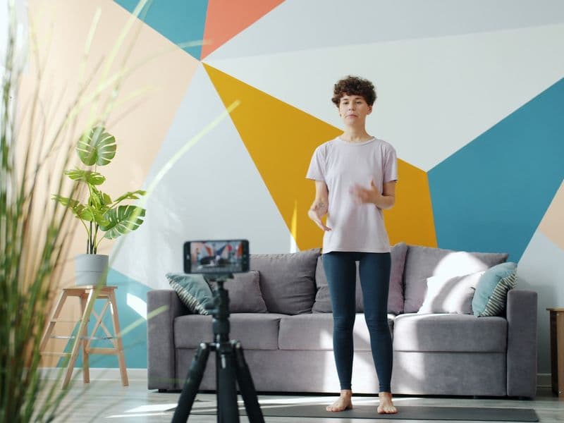 A person exercising in a small living-room space at home