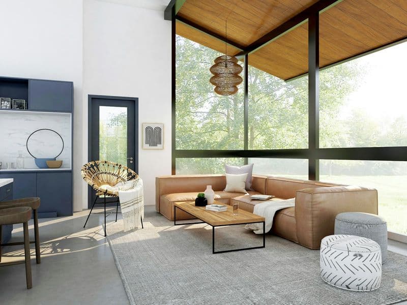 A styled outdoor patio living space with seating, shade, and a rug grounding the area
