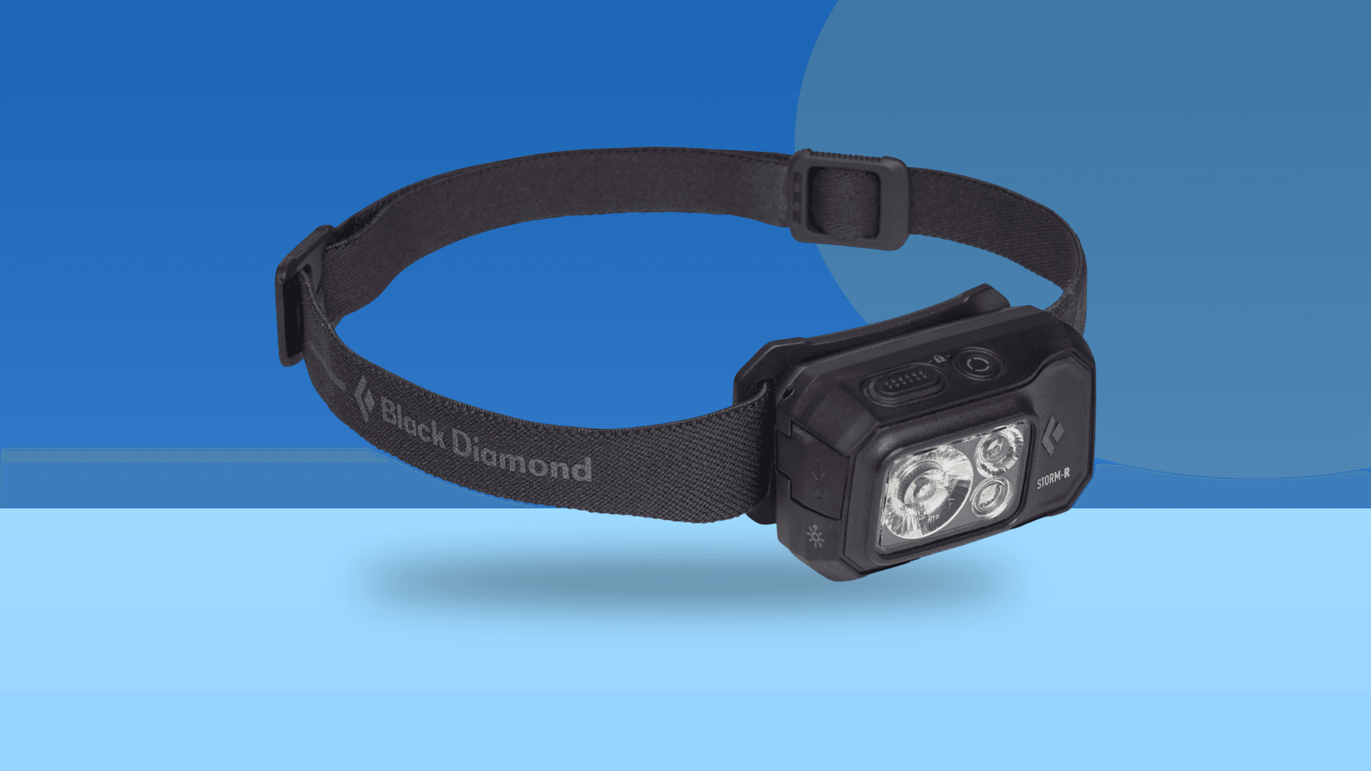 Black Diamond Storm 500-R rechargeable headlamp on a blue composite background