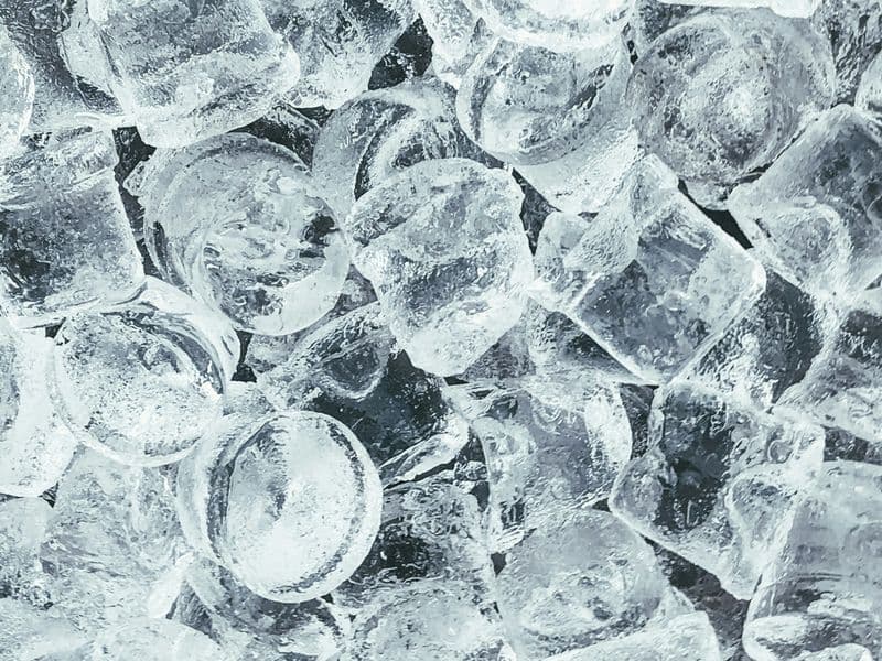 Cooler packed with ice and drinks at an outdoor gathering