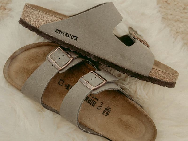 Flat strappy women's summer sandals styled with a light dress for warm weather