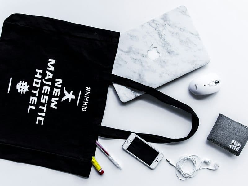 Minimalist everyday-carry flat lay with a slim wallet, phone, and pocket essentials on a clean surface