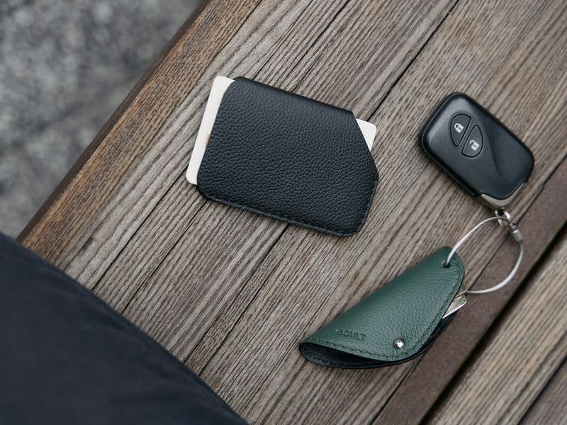 Slim minimalist wallet, phone and keys on a table, front-pocket everyday carry