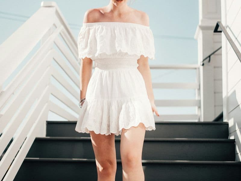 Woman wearing a casual summer sundress on a sunny beach vacation