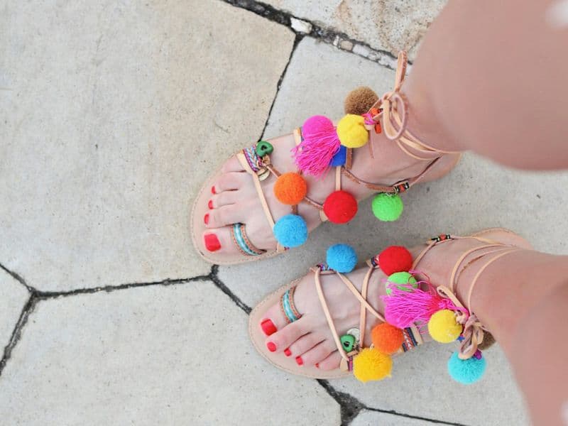 Woman wearing flat summer sandals walking outdoors in warm weather